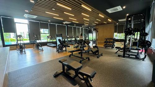 a gym with several treadmills and machines in it at Bandar Gamuda Cove Splash Mania Fully Air Con Suite, 42700 Banting, Selangor in Banting