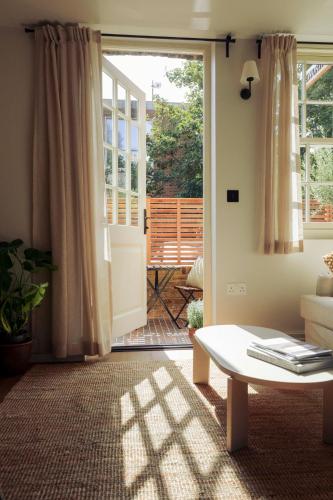 a living room with a door open to a patio at Leworth Apartments, Windsor in Windsor