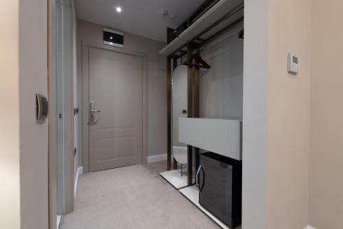 a room with a fireplace and a hallway with a door at Reea Boutique Hotel in Târgovişte
