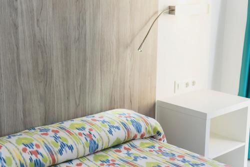 a room with a couch with a lamp and a table at Hotel Amic Can Pastilla in Can Pastilla