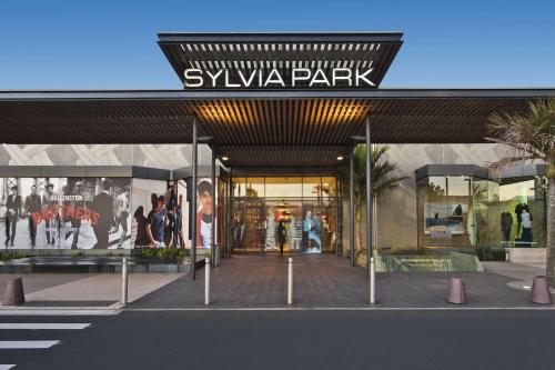 a shopping mall with a sign on the front of it at Bright&Cozy Room with attached private bathroom - On street parking only in Auckland