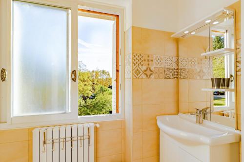 a bathroom with a sink and a window at Maison de vacances in Sarlat-la-Canéda