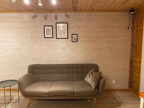 a couch sitting in a room with a wall at La Casa Marrone Norway in Asker