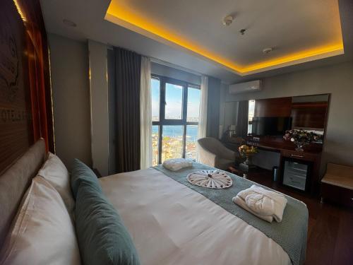 a bedroom with a large bed with towels on it at Grand Star Hotel Premium in Istanbul