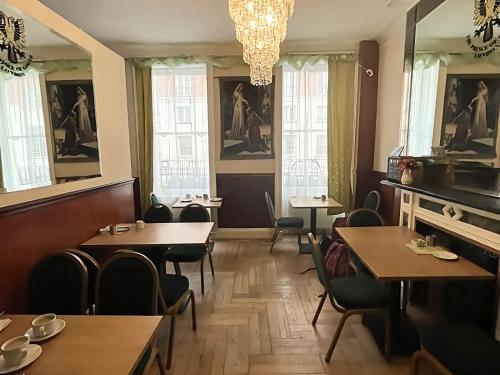 un restaurant avec des tables, des chaises et des fenêtres dans l'établissement The Marker Hotel, à Londres