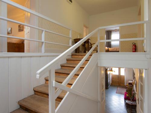 a staircase with white railings in a house at The old Village Villa At 2 Geese with Pool in Pišece