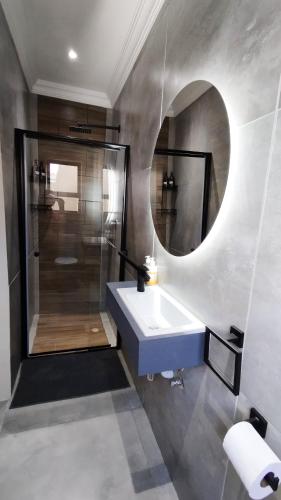 a bathroom with a sink and a mirror at DINAS Self-Catering Accommodation Flat 2 in Oranjemund