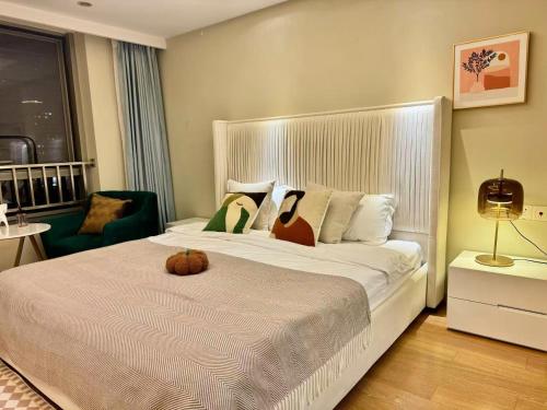 a bedroom with a large bed with a pumpkin on it at Shanghai Lerongju Boutique Apartment Metro Line 8 20meter in Shanghai