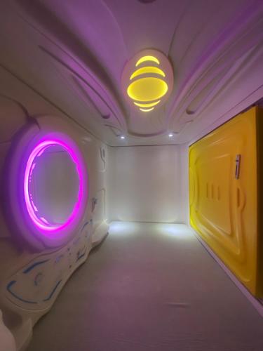 a room with a mirror and purple lights at Mermaid Space Capsule Hostel Palermo in Palermo