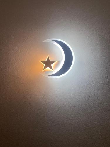 a star and a crescent moon on a wall at Mermaid Space Capsule Hostel Palermo in Palermo