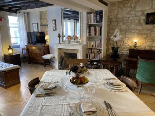 une salle à manger avec une table avec un bol de fruits dessus dans l'établissement Nid douillet au cœur de Paris, à Paris