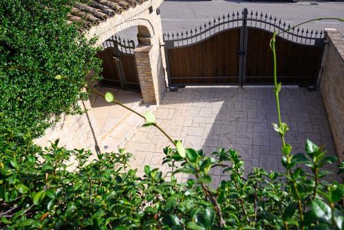 a brick patio with a fence and a gate at Villa Klaudja in Pianella