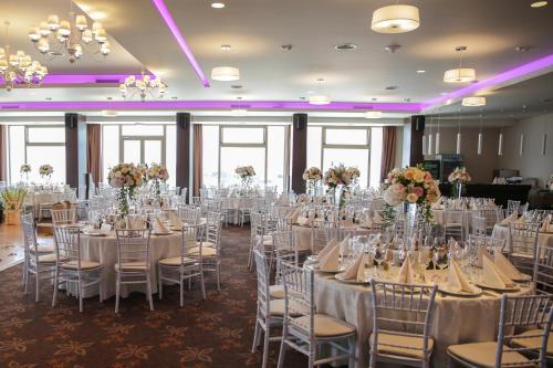 a set up for a wedding in a ballroom with tables and chairs at Hotel Belvedere in Braşov