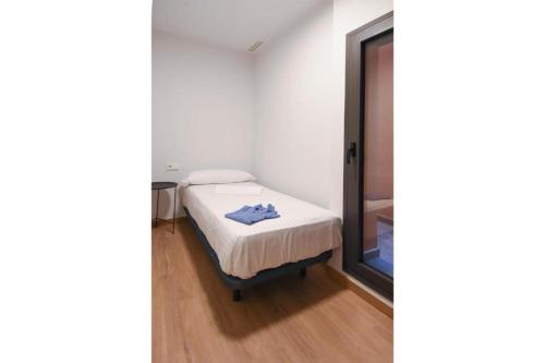 a small bedroom with a bed and a window at APG Girona Carme 19 in Girona