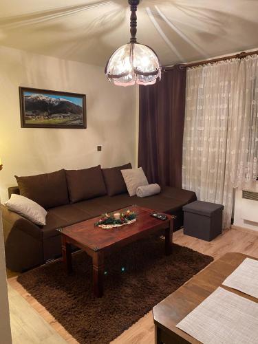 a living room with a couch and a table at Privát Vavrúš in Donovaly