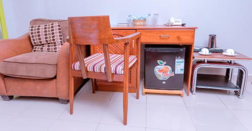 a desk with a chair next to a desk with a desk at Selig Hotel in Moshi