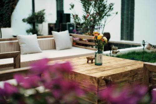 a vase of flowers sitting on a wooden table at Party House in Baisha