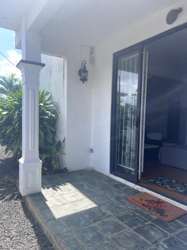 a porch of a house with a large glass door at Teisha House in Souillac