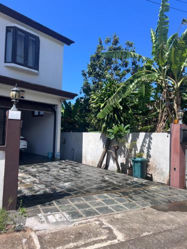 a house with a garage and a fence at Teisha House in Souillac