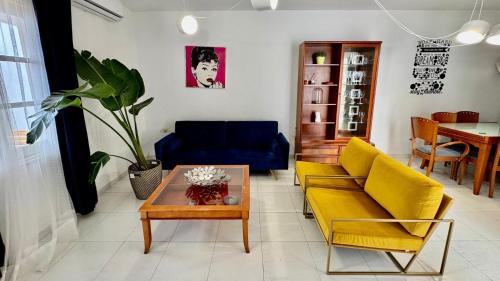 a living room with a couch and a table at Le Family Palms Private Oasis with Terrace & BBQ in Playa Honda