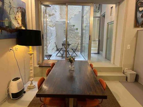 a dining room with a wooden table and chairs at Oporto Downtown Almada Garden Apartments by LuxiStay in Porto
