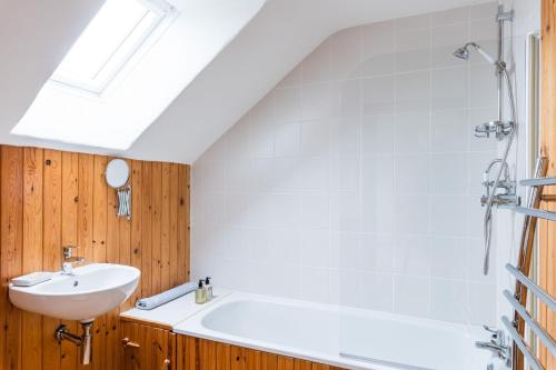 a bathroom with a sink and a bath tub at Harmony in Goodwick