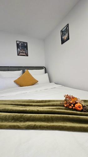 a white bed with a flower arrangement on it at Wild House in Sinaia
