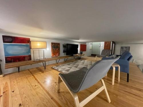 a living room with a couch and a living room with at Oporto Downtown Almada Garden Apartments by LuxiStay in Porto