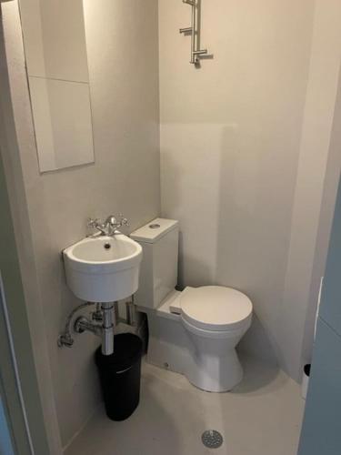 a small bathroom with a toilet and a sink at Oporto Downtown Almada Garden Apartments by LuxiStay in Porto
