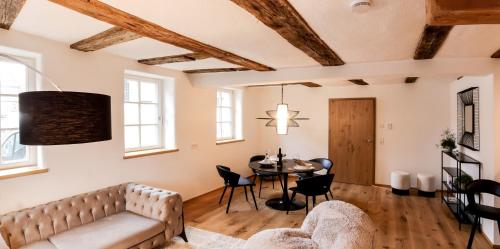 a living room with a couch and a table at Gasthaus Faust in Knittlingen