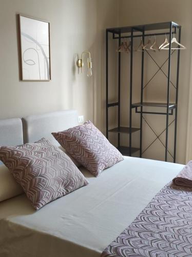 a bed with two pillows on it in a room at Ta-49 bed e breakfast in Naples