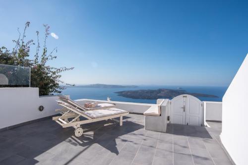 a view of the ocean from the balcony of a house at Karpimo Horizon - Caldera View with private hot tub in Firostefani