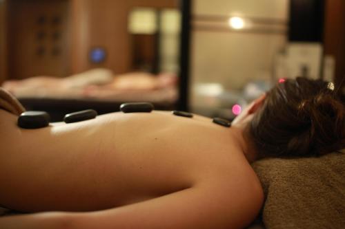 a naked woman laying on a couch with a necklace on her back at Divan Istanbul in Istanbul