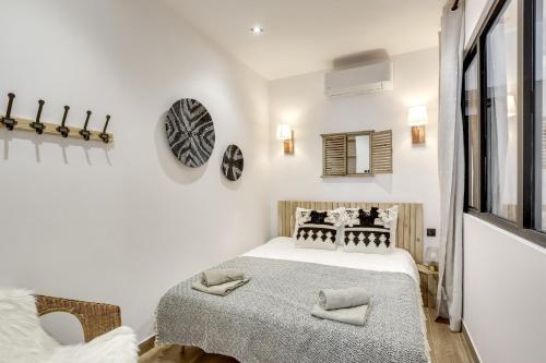 une chambre blanche avec un lit et une fenêtre dans l'établissement Bluestay 25 - Charmant appartement à Paris 12, à Paris