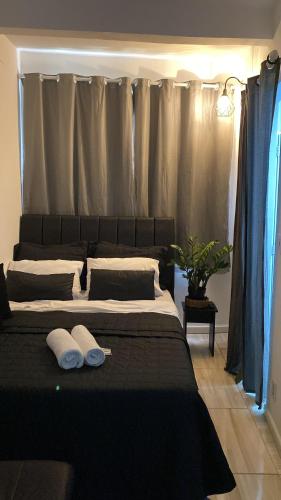 a bedroom with a large bed with two pillows on it at Apêzinho Vidigal - RJ in Rio de Janeiro