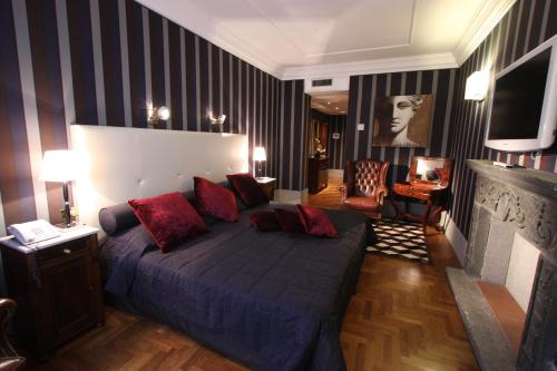 a bedroom with a large bed with red pillows at The Inn at the Spanish Steps Luxury Collection - The Inn at the Spanish Steps in Rome