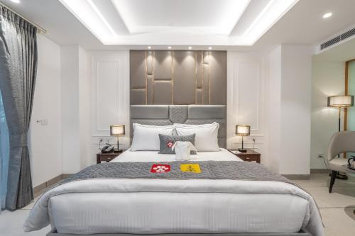 a bedroom with a large bed and a chair at Mastiff Select Mandavya Dharamkot, McLeodganj in Dharamshala