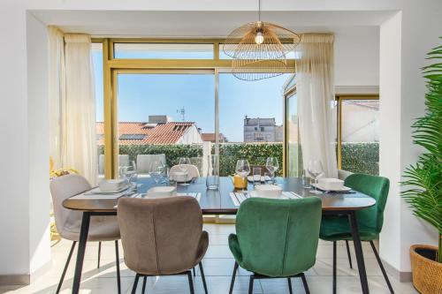 une salle à manger avec une table et des chaises et une grande fenêtre dans l'établissement Hypercentre - Palais - Croisette - Plage - CI, à Cannes