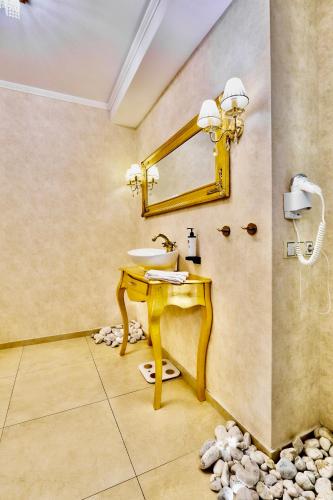 a bathroom with a sink and a mirror at Restauracja Joanna in Kluczbork