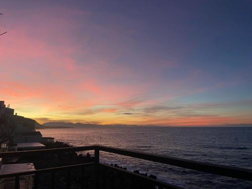 a sunset over the ocean with a fence at Terrazza Roberto in Cefalù