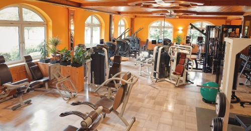 a gym with many exercise equipment in a room at Sattelbogener Hof in Traitsching