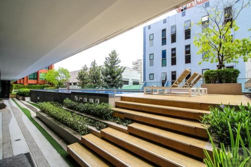 a group of stairs in a city with a building at brown condo Phahon67 in Ban Chuat Plai Mai