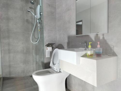 a bathroom with a white sink and a toilet at Riveria City at KL Sentral by KKT in Kuala Lumpur