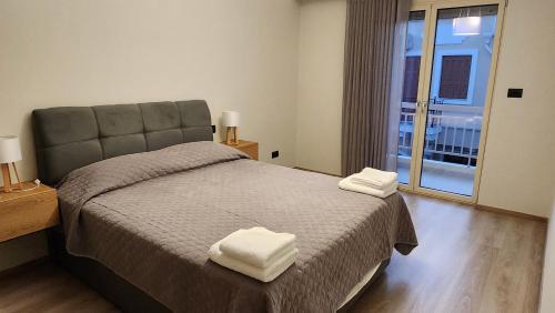 a bedroom with a bed with two towels on it at Patras Aura - Old Town in Patra
