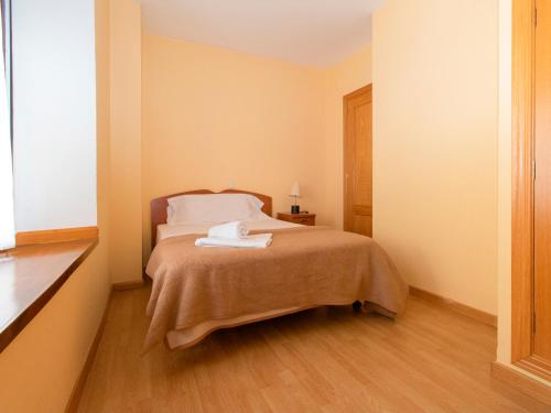 A bed or beds in a room at Apartamentos Canfranc 3000
