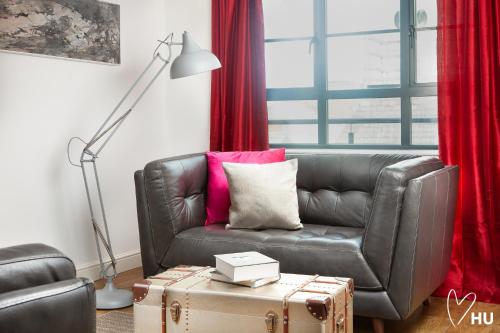 a living room with a leather couch and a lamp at Boutique 1 Bdrm Duplex Suite on Marina 305 in Hull