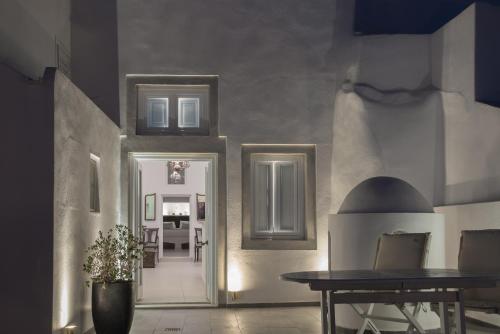 a hallway with a table and a dining room at Karpimo Horizon - Caldera View with private hot tub in Firostefani