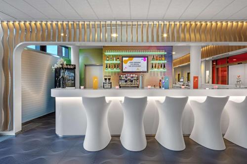 a lobby with a white counter in a store at Prize by Radisson, Bremen City in Bremen
