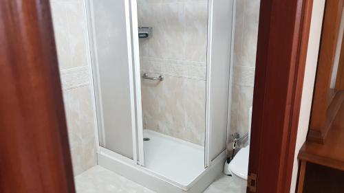 a shower with a glass door in a bathroom at CASA LOZANO in Barreiros
