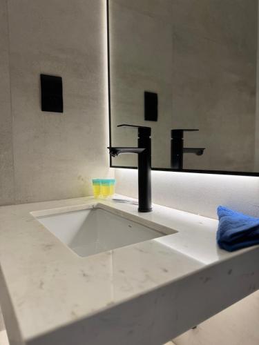 a bathroom sink with a faucet and a mirror at Jumeirah Heights in Dubai